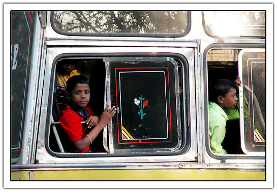 Indian boy at back of bus wiht window open (55kb)